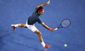 Roger Federer goes for a backhand volley in Melbourne(thanks to the guardian.com)
